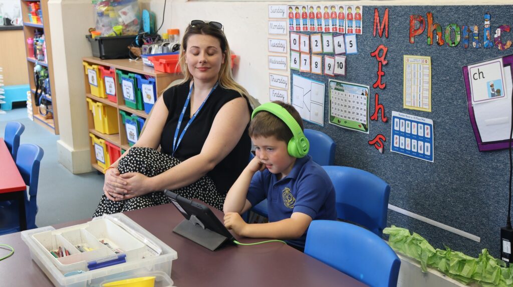 A teacher with pupils at Exning Primary School