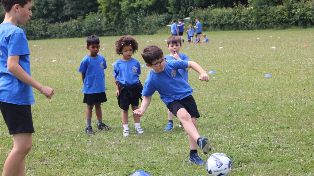 Pupils at Exning Primary School playing football