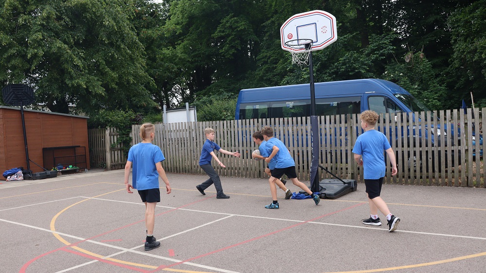 Pupils playing basketball at Exning Primary School